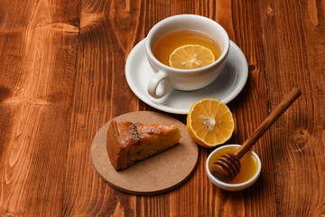 Cup of green tea with slice of orange fruit.