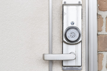 Silver door handle and white wood door