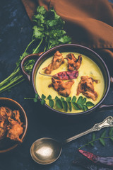 Punjabi Kadhi Pakoda or curry Pakora, Indian cuisine served in a bowl or karahi, selective focus