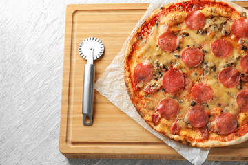 Tasty pepperoni pizza on wooden board