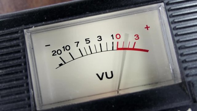 Vintage tape recorder analog VU meter with needle moving.  