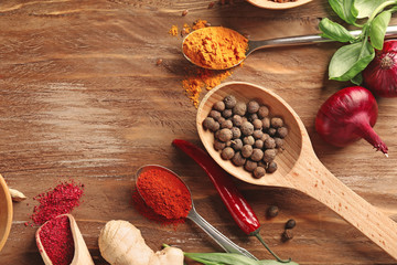 Composition with different spices on wooden background