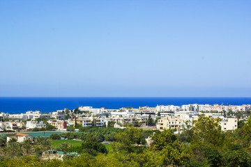 Fototapeta na wymiar Landscape of town Paphos and sea against blue sky, Cyprus