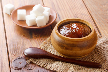 jam in wooden cann on wooden table
 