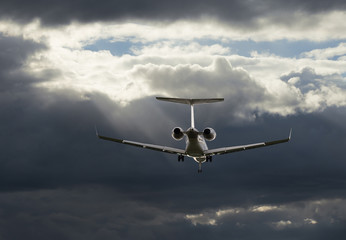 Airplane flying in sky with clouds at sunset time