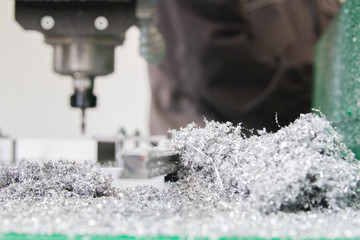 Industrial machine at factory and metal shavings at metal-working factory