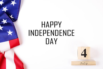 Ruffled American flag and wooden cube calendar with 4th of July congratulations. Happy Independence...
