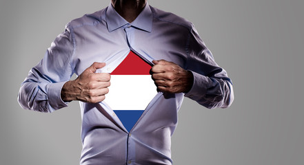Business man with Dutch flag on gray background - 209069603