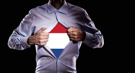 Business man with Dutch flag on black background - 209069695