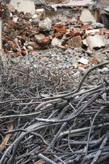 Tangled steel rebar in front of pile of rubble at a construction site in Hanoi Vietnam