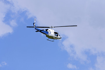 Blue helicopter flight in the sky