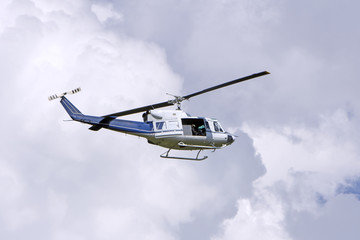 Naklejka na ściany i meble Blue helicopter flight in the sky