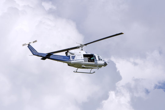 Blue helicopter flight in the sky