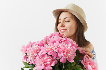 Fototapeta premium Close up young tender woman in dress hat holding, sniffing bouquet of pink peonies flowers isolated on white background. St. Valentine's Day International Women's Day holiday concept. Advertising area