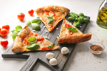 Composition with slices of delicious pizza Margherita on light background