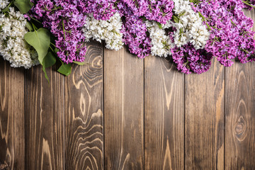 Beautiful blossoming lilac on wooden background