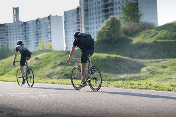 Obraz premium Active male athletes riding bicycles on an open country road