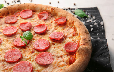 Delicious pizza with salami on table, closeup