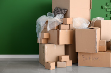 Carton boxes and interior items in room. Moving house concept