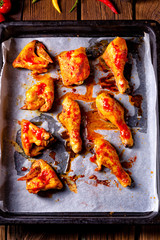 Rustic backed chicken wings,legs on baking tray