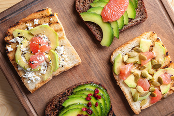 Tasty toasts on wooden board