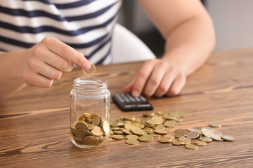 Fototapeta premium Man counting his savings at table