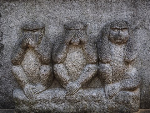 Three wise monkeys who see and hear and speak no evil