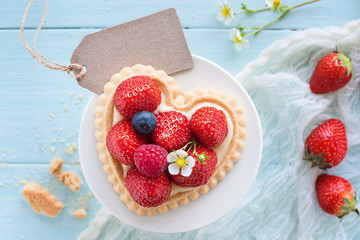 Erdbeerkuchen in Herzform mit kleiner Grußkarte