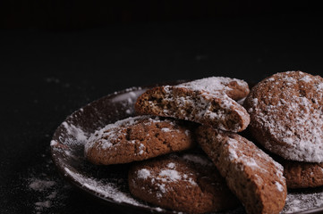 oatmeal cookies on a black table in castor sugar