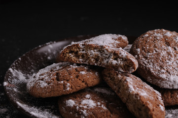 oatmeal cookies on a black table in castor sugar