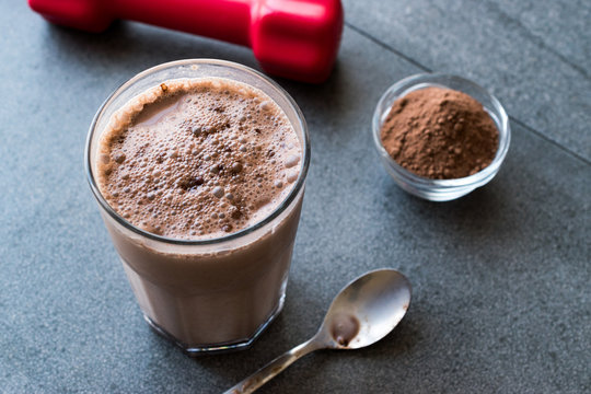 Chocolate Protein Shake Smoothie with Whey Protein Powder and Red Dumbbells