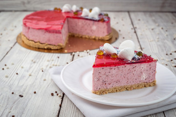Strawberry Cake dessert with candies on wooden background
