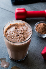 Chocolate Protein Shake Smoothie with Whey Protein Powder and Red Dumbbells