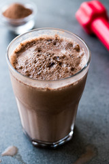 Chocolate Protein Shake Smoothie with Whey Protein Powder and Red Dumbbells