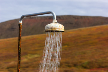Naklejka na ściany i meble Outdoor geothermally heated shower near Krafla power station in Iceland