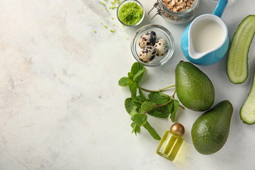 Avocado with ingredients for natural homemade cosmetics on light background