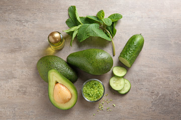Avocado with ingredients for natural homemade cosmetics on grey background