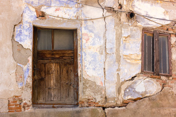 Weathered façade with tiny window and door in the Old Bazaar area of the city