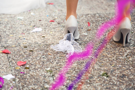 Wedding concept female shoes from back many confetti