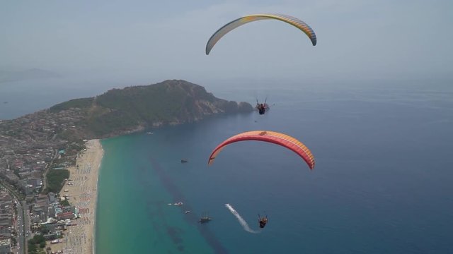 Tourists fly by paragliding and explore Cleopatra's beach