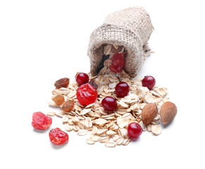 Fototapeta na wymiar Sack with scattered oatmeal flakes, berries and nuts on white background