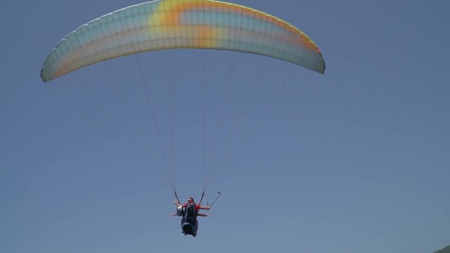 Tourists take a flight on paragliding