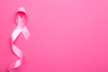 Pink ribbon on color background. Breast cancer concept