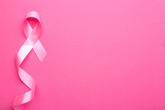 Pink ribbon on color background. Breast cancer concept