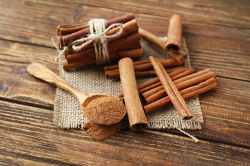 Fototapeta na wymiar Composition with cinnamon sticks on wooden background