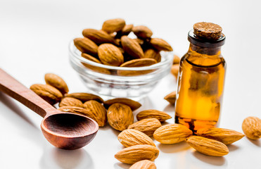 organic cosmetic with almond extract on table background