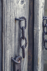 Old rusty metal latch on wooden door
