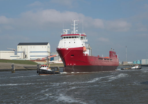 Freightship with towboat. Netherlands. Harbor. Coaster