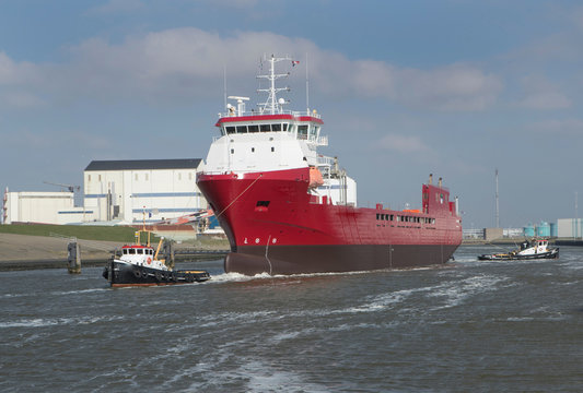 Freightship with towboat. Netherlands. Harbor. Coaster
