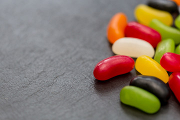 Jelly beans candy sweets dark background with copy space